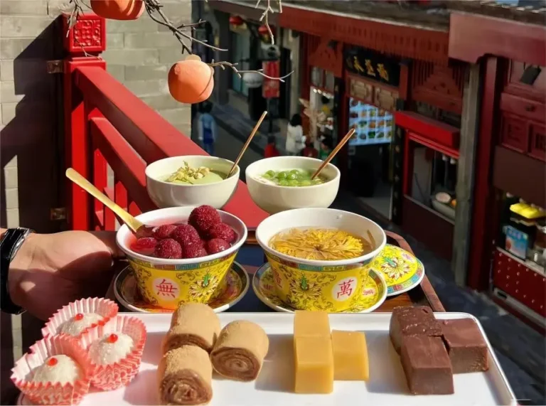 Assorted authentic Beijing desserts served with chrysanthemum tea on Beijing Local Food Trails, showcasing traditional sweet treats