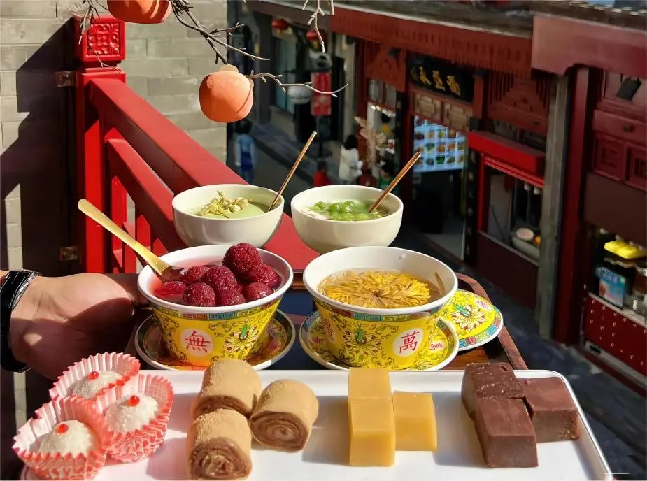 Assorted authentic Beijing desserts served with chrysanthemum tea on Beijing Local Food Trails, showcasing traditional sweet treats