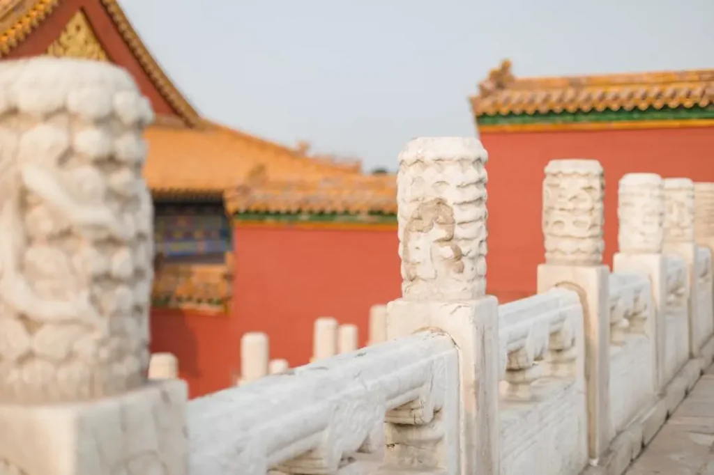 Sunset view of the Forbidden City in Beijing with white marble balustrades glowing in the evening light