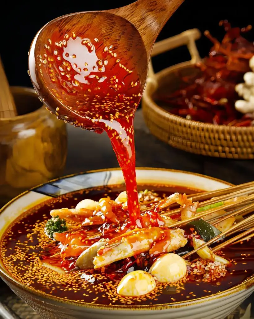 Close-up of Chengdu spicy boboji, a traditional Sichuan dish with skewered ingredients in red chili oil