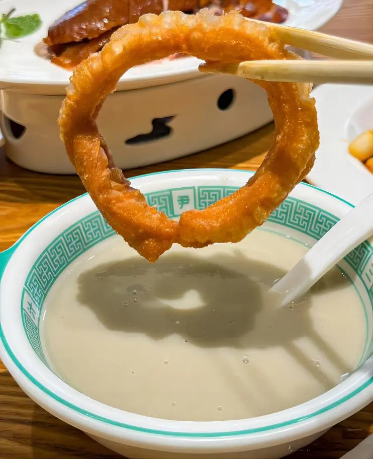 Douzhi (fermented mung bean drink) served with crispy Jiaochuan in Yin San Douzhi shop, authentic Beijing local food