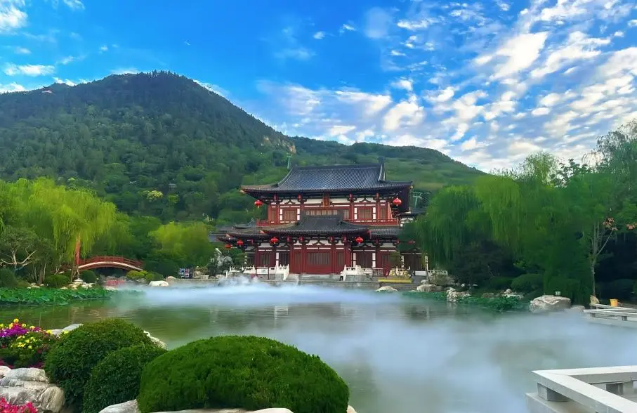 Huaqing Palace courtyard with red walls, green tiles, and reflections in the water in Xi’an, China