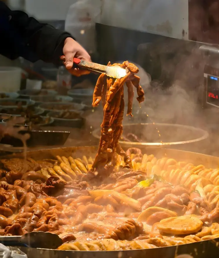 Luzhu Huoshao, traditional Beijing street food with stewed pork offal and baked wheat dough in bustling market