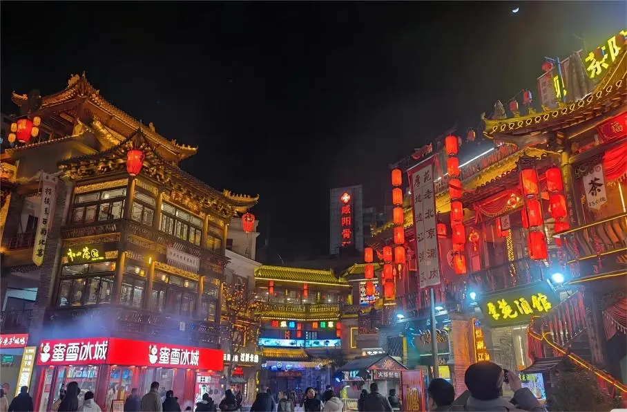 Nanluoguxiang at night in Beijing, illuminated hutongs and lively street atmosphere, perfect for a Beijing Day Trip Itinerary