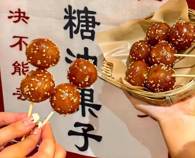 Close-up of Tangyou Guozi, a classic Chengdu street food snack often enjoyed at night markets, crispy outside and sweet inside