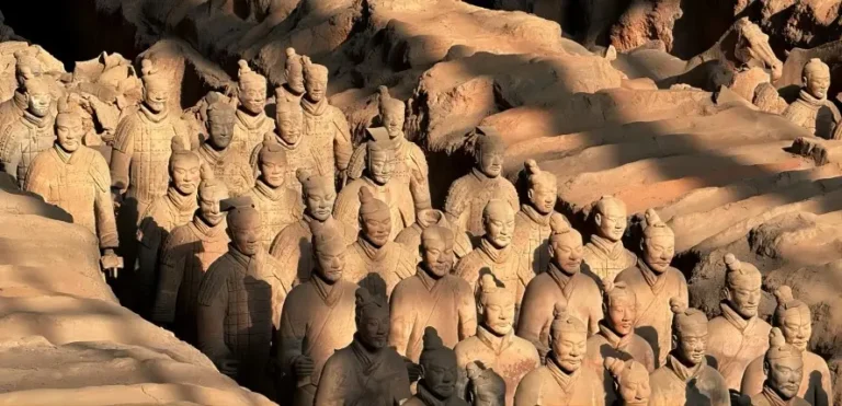 Terracotta Army in Xi’an at sunset – golden light illuminating life-sized warriors with travel tips