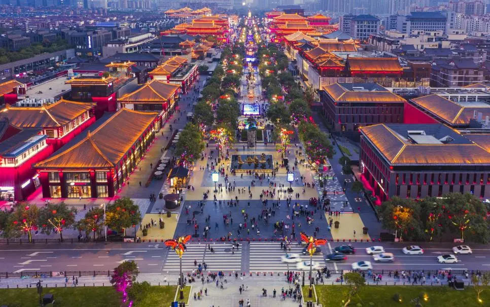 Night aerial view of Xi’an Datang Evernight City, featuring illuminated streets and vibrant urban scenery