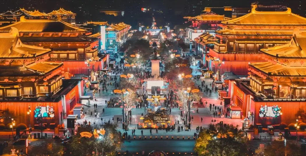 Aerial view of Xi’an Datang Everbright City at night, showcasing illuminated streets and vibrant cityscape