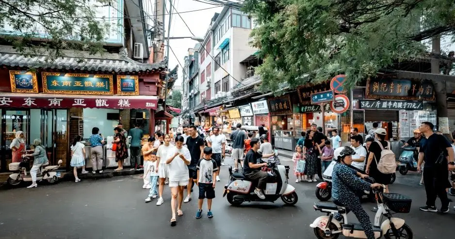 Xi’an local food trail street view with steaming street food and bustling crowd