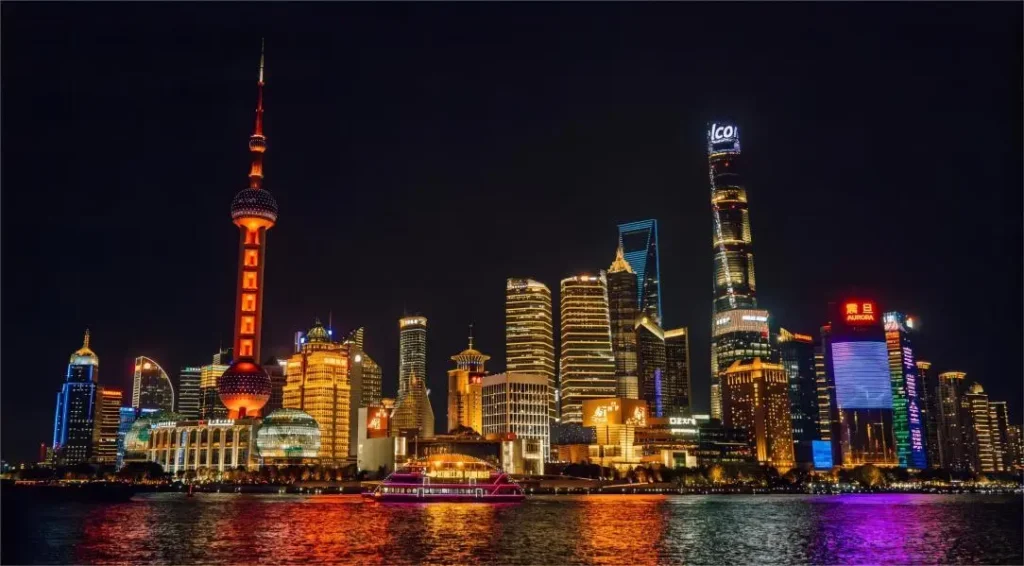 Lujiazui night skyline featuring the Oriental Pearl Tower and surrounding skyscrapers reflecting on the Huangpu River