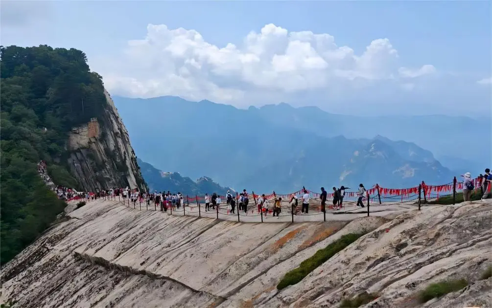 Panoramic view of Mount Hua cliffside walkway, showcasing the daring path along the mountain.