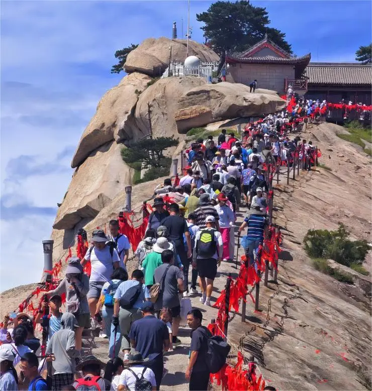 Hikers exploring Mount Hua trails, experiencing the mountain’s scenic and challenging terrain.