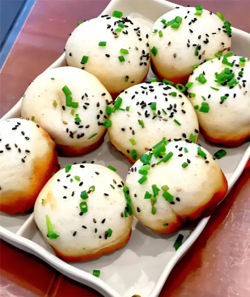Pan-fried Shengjianbao, crispy bottom with juicy pork filling, a street food favorite in Shanghai