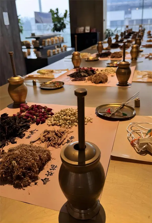 Practitioner preparing herbs using traditional methods at Tong Ren Tang Beijing, demonstrating centuries-old TCM techniques.