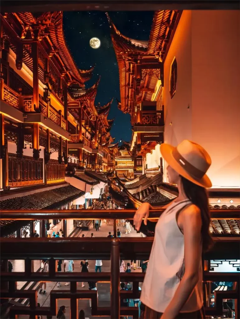 Night view of Yuyuan Garden Shanghai from visitor’s perspective, illuminated traditional architecture and glowing ponds