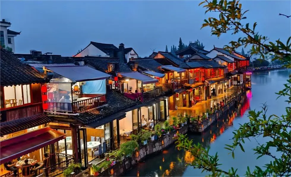 Visitor sitting outside a traditional shop along Zhujiajiao street, enjoying the local atmosphere.