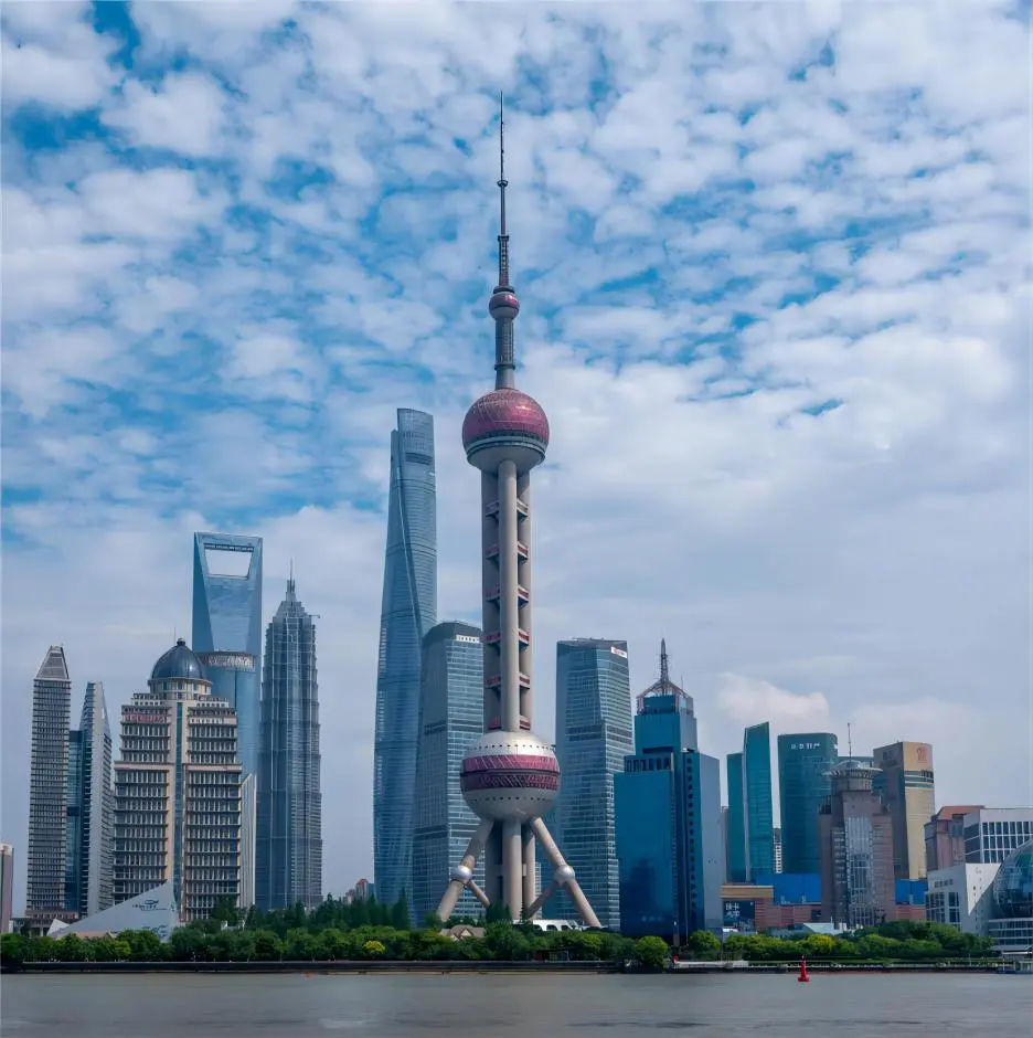 Daytime view of the Oriental Pearl Tower in Lujiazui, Shanghai, under clear blue sky showing its iconic pearl-shaped structure