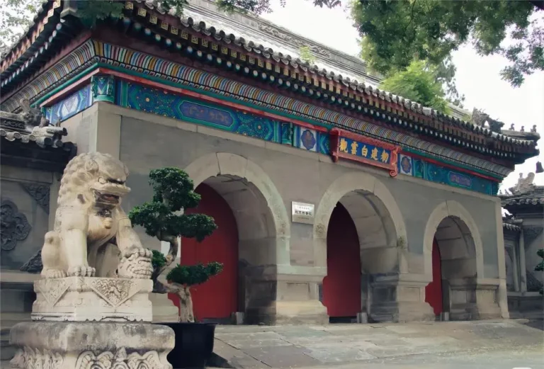 Main entrance of Baiyun Temple in Beijing, showing the red walls and the ancient plaque of the White Cloud Daoist Temple.