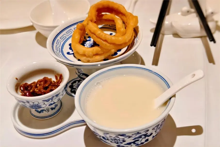 Traditional Old Beijing Douzhier paired with crunchy Jiaoquan, a must-try local breakfast.