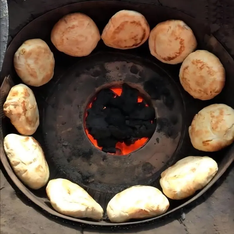 Traditional Beijing huoshao baking inside a clay oven, showcasing the crispy and aromatic Beijing snack.