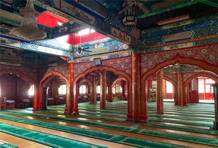 Interior of the prayer hall at Beijing Niujie Mosque, showing the solemn worship space and traditional architectural style.