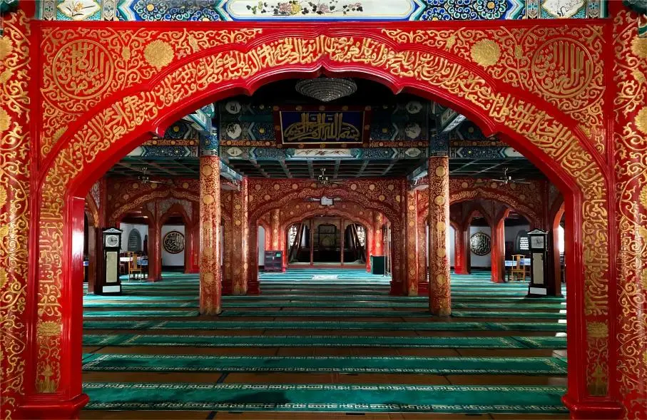 Detailed interior view of the prayer hall at Beijing Niujie Mosque, highlighting distinctive Islamic architecture and decorative elements.