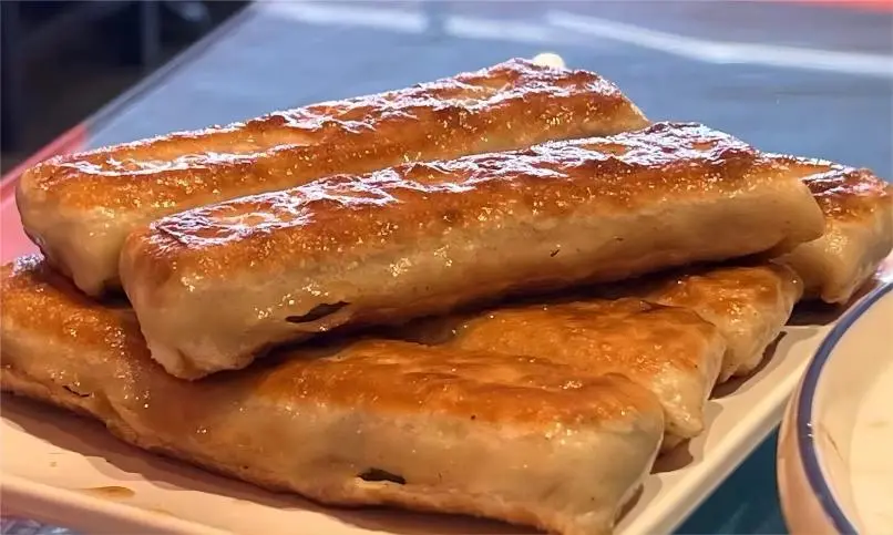 Handcrafted Dalian Huoshao from Beijing, showing flaky crust and juicy filling