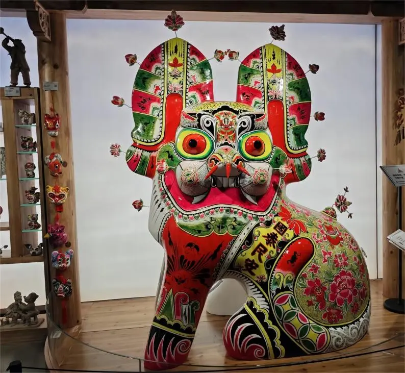 Shaanxi Fengxiang Clay Sculpture of a Sitting Tiger on display at Shaanxi Provincial Cultural Center, traditional Xi’an folk art.
