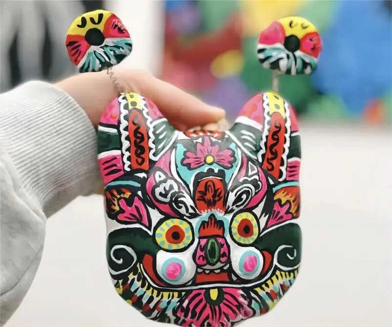 Fengxiang Clay Sculpture Tiger Head Hanging Piece (Hutou Guapian), traditional Xi’an folk art used for newborn protection.