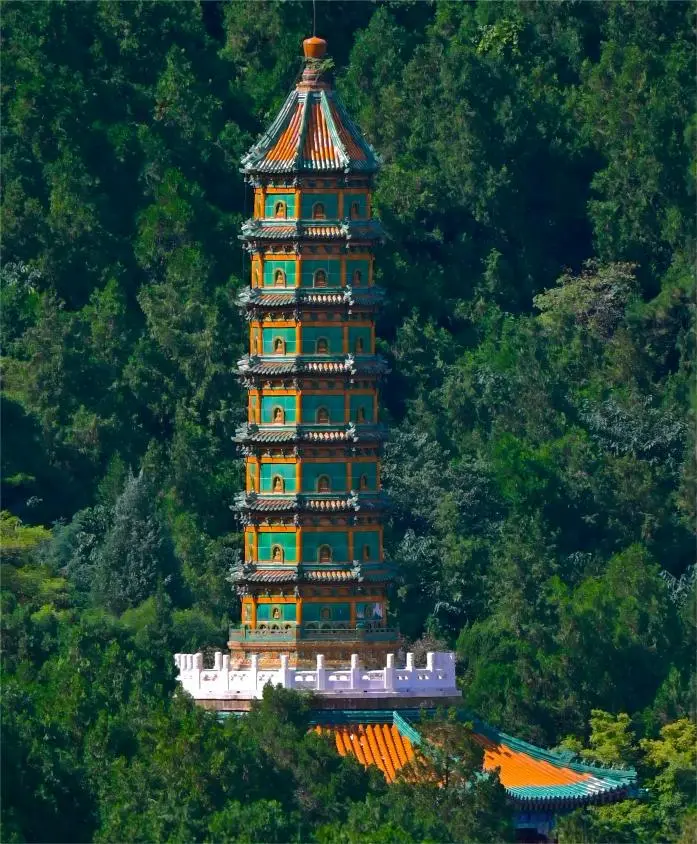 Zhaomiao Glazed Wanshou Pagoda in Fragrant Hills Park Beijing surrounded by blooming spring flowers.