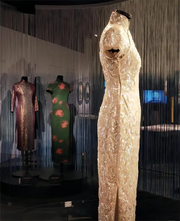 White Haipai Qipao on display at Shanghai exhibition, showcasing intricate embroidery and traditional craftsmanship