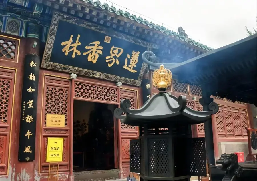 Worshippers praying with incense at Jietai Temple in Beijing, a spiritual sanctuary of Zen and blessings