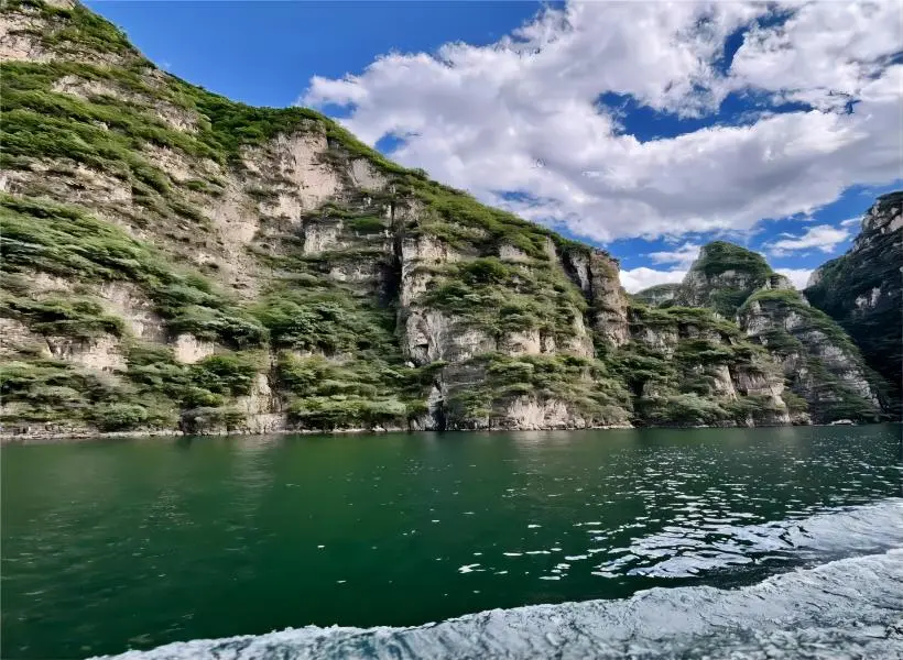 Stunning mountain reflections on the lake during Longqing Gorge boat tour