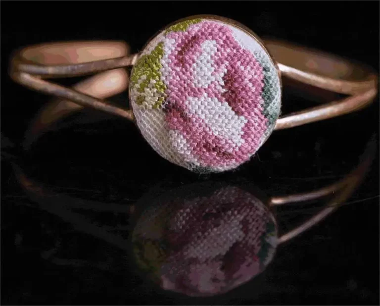 Close-up of a ring with Shanghai Wool Embroidery (Rongxiu) design, showcasing fine threadwork on jewelry