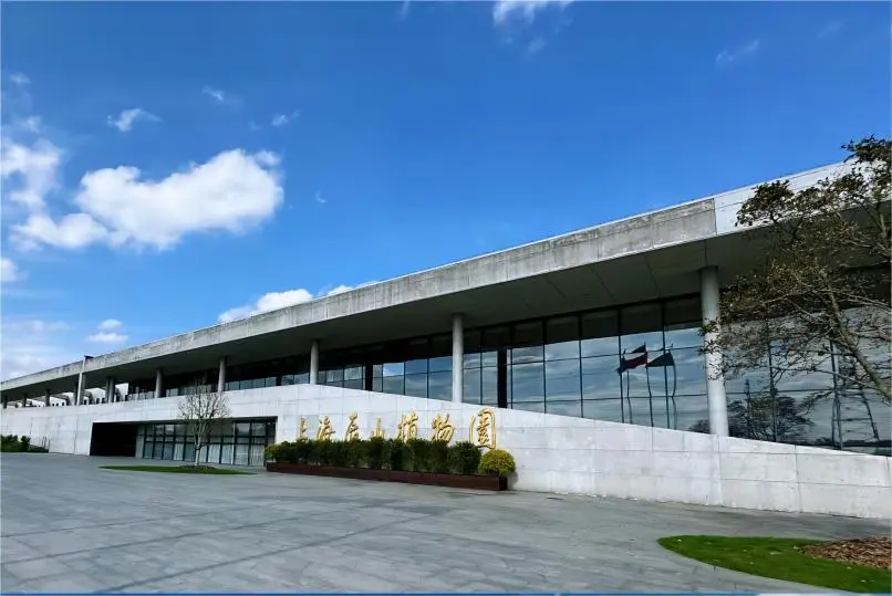 Main entrance of Shanghai Chenshan Botanical Garden with visitors entering the nature park.