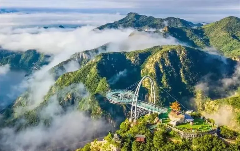 Panoramic distant view of the Shilin Gorge UFO Glass Viewing Platform suspended above the canyon, a highlight of this geological wonder.