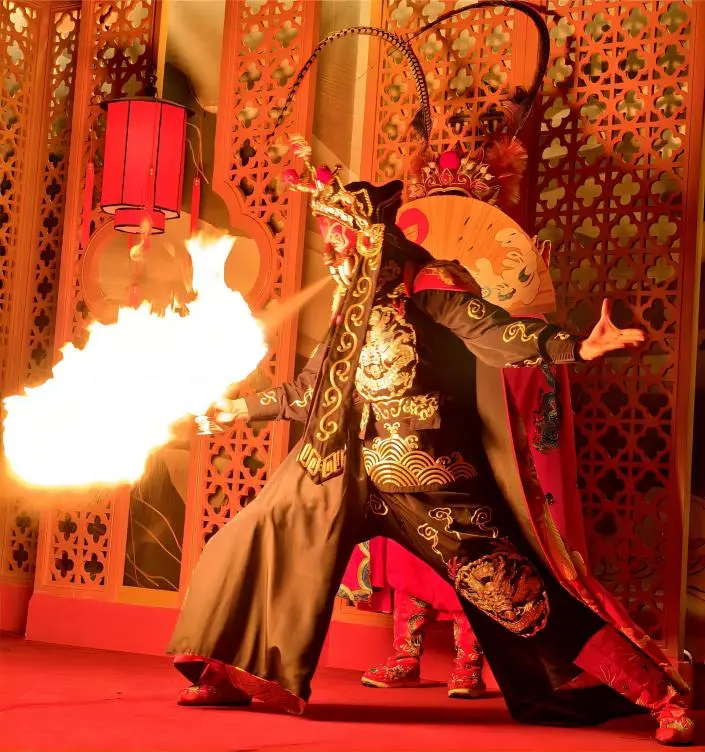 Fire-spitting act during Sichuan Opera face changing performance in Chengdu