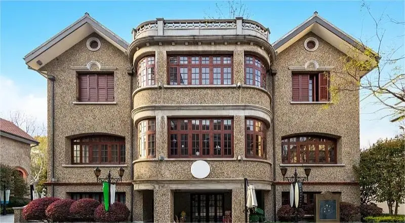 Heritage building in Sinan Mansions Shanghai surrounded by plane trees, representing Old Shanghai charm.