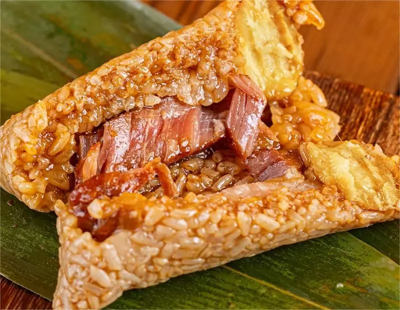 Southern-style meat zongzi with tender pork filling, representing classic Jiaxing and Jiangnan flavors.