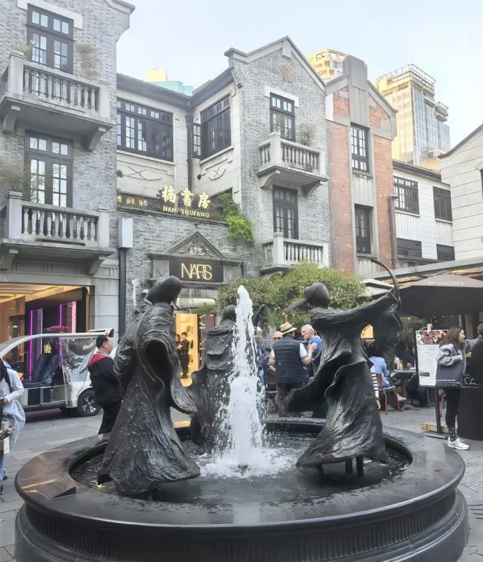 Daytime street view in Xintiandi with tree-lined lanes and Shikumen buildings, ideal for an Xintiandi Shanghai travel guide.