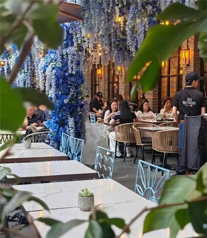 Sunny daytime scene in Xintiandi showing cafés and restored Shikumen façades, popular among visitors exploring Shanghai.