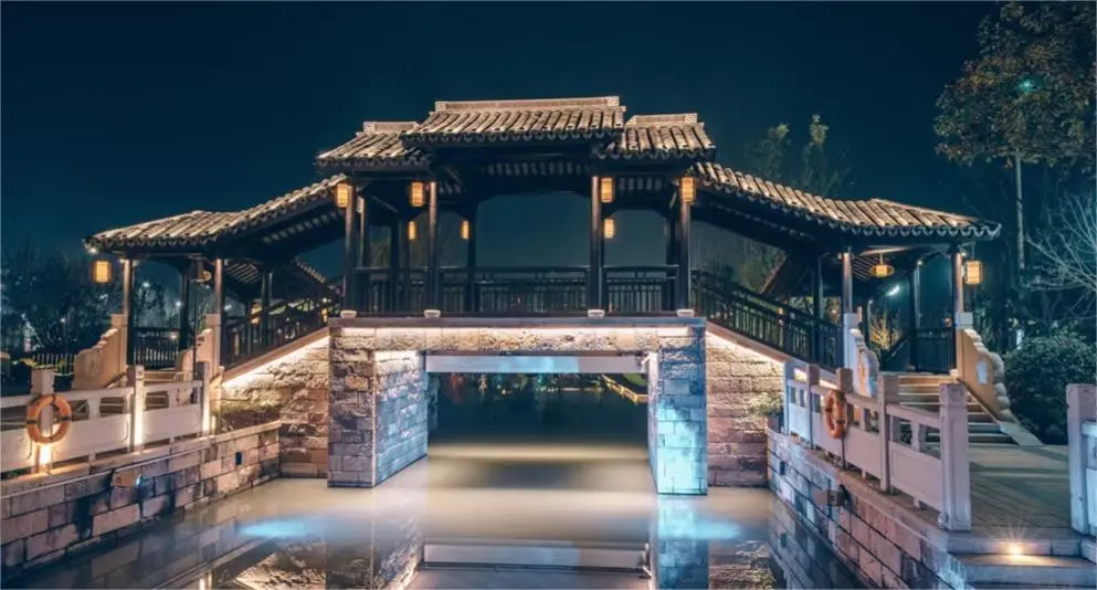 Night scene of an ancient bridge in Xitang Water Town from Shanghai, illuminated along the canal.