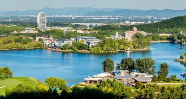 Distant view of Yanqi Lake in Beijing, showcasing the lake nestled among the surrounding mountains.