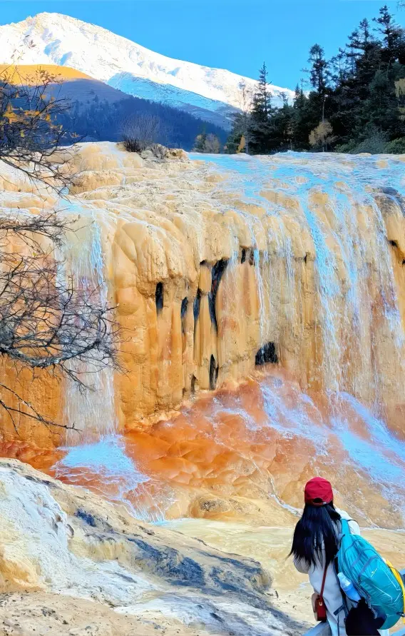 Body Washing Cave behind travertine waterfall at Huanglong Scenic Area