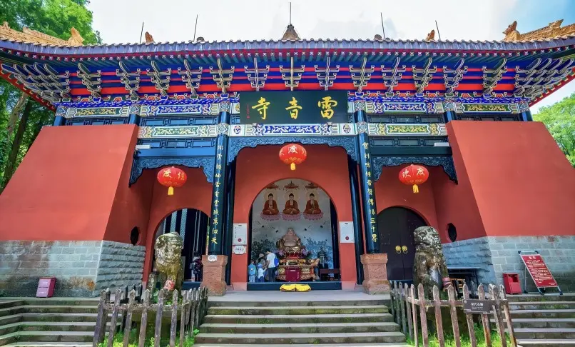 Leiyin Temple gate at Tiantai Mountain, a historic Buddhist site surrounded by forest.