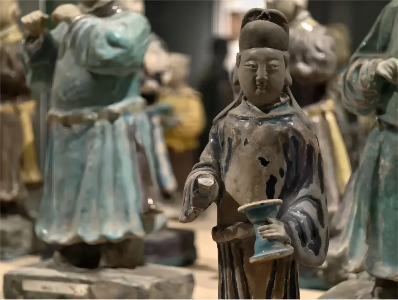 Exhibit of Ming Dynasty pottery figurines from the Ming Shu Royal Tombs in Chengdu, highlighting detailed carving and burial culture.