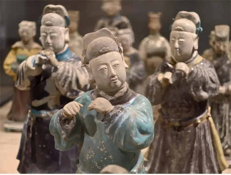 Pottery figurines excavated from the Ming Shu Royal Tombs on display in the Chengdu exhibition hall, showing Ming Dynasty craftsmanship.