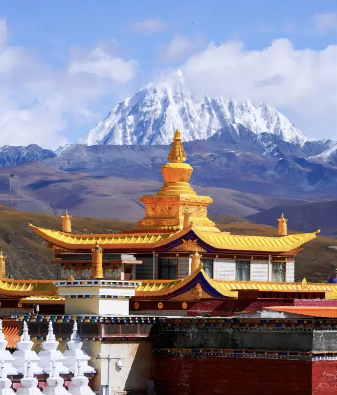 Muya Golden Stupa on Tagong Grassland with prayer flags and snow mountains