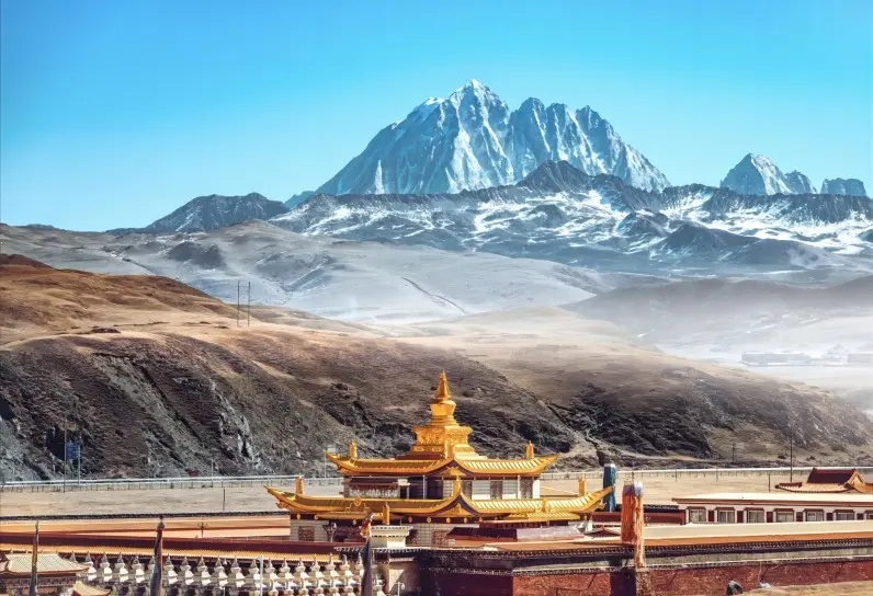 Muya Golden Stupa with snow-capped mountains on Tagong Grassland in Western Sichuan