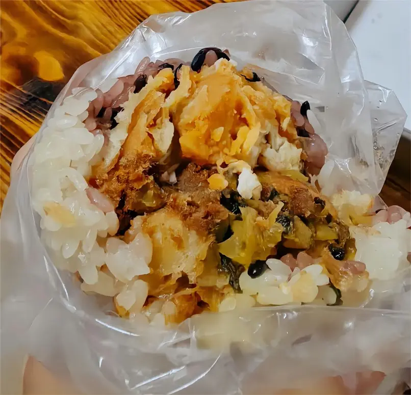 Detailed view of Cifan Tuan (Sticky Rice Roll) from Shanghai, highlighting sticky rice and pork floss